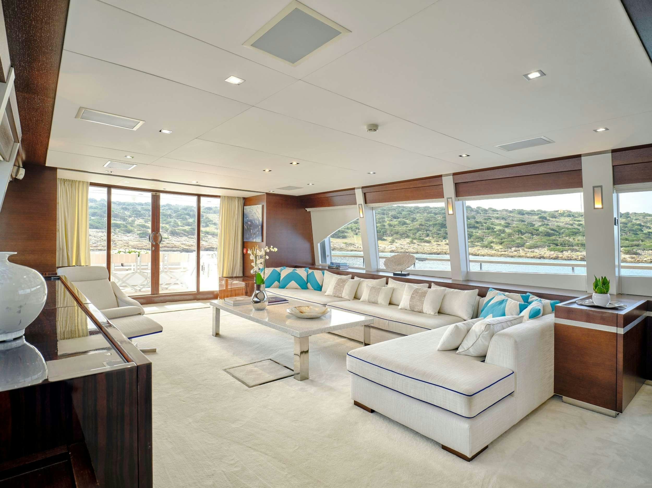 a living room with a large window aboard HAKUNA MATATA Yacht for Charter