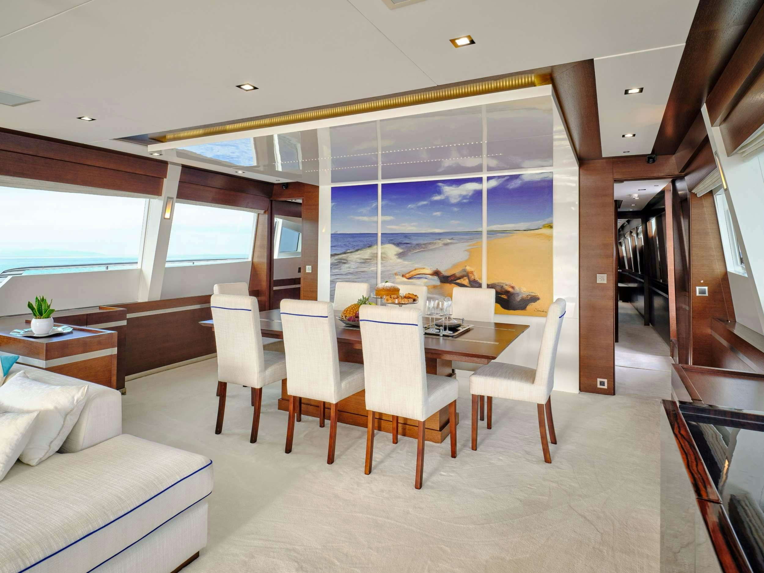 a room with a table and chairs aboard HAKUNA MATATA Yacht for Charter