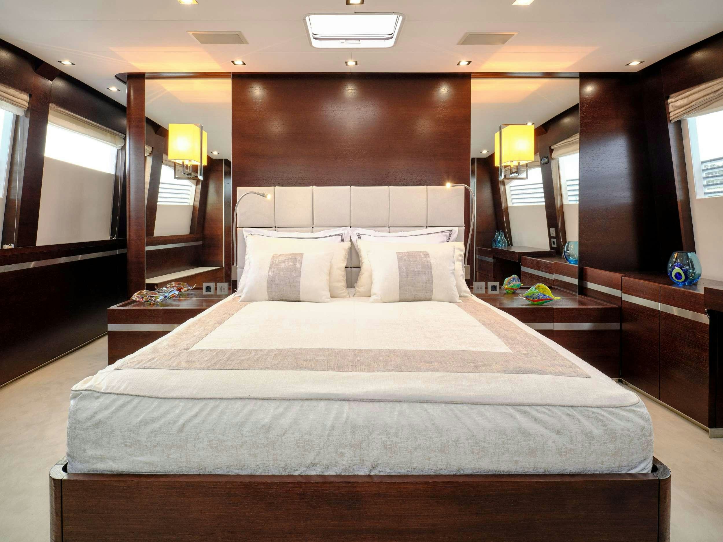 a bed with white sheets aboard HAKUNA MATATA Yacht for Charter