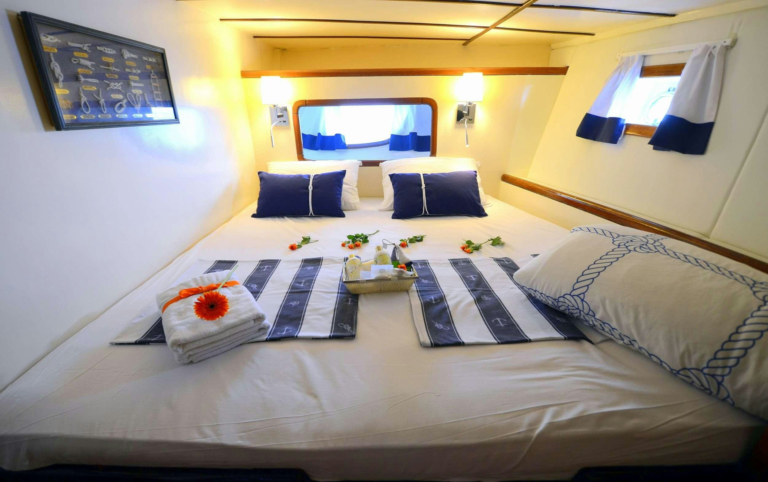 a bed with a laptop on it aboard FORTUNA Yacht for Charter