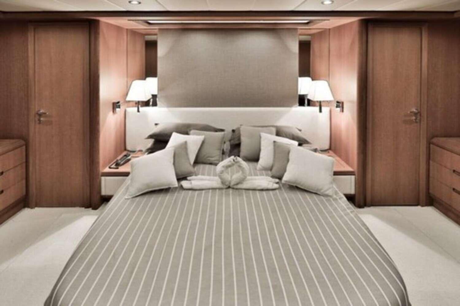 a large bed in a hotel room aboard RESILIENCE Yacht for Charter