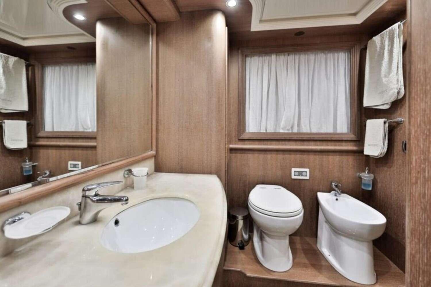 a bathroom with a toilet and sink aboard RESILIENCE Yacht for Charter