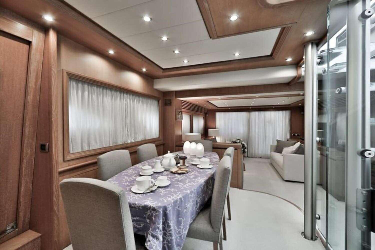 a dining room with a table and chairs aboard RESILIENCE Yacht for Charter