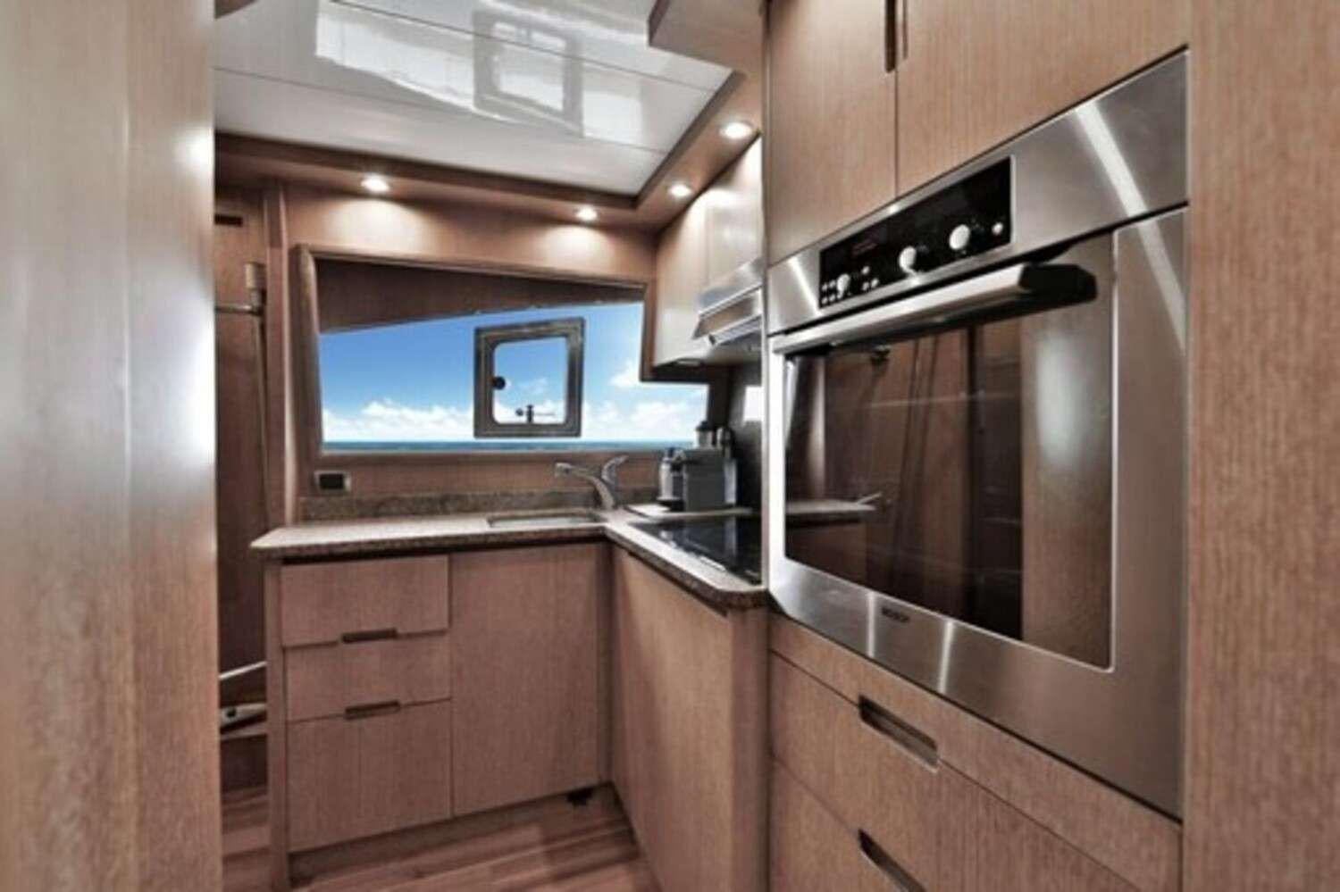 a kitchen with wooden cabinets aboard RESILIENCE Yacht for Charter