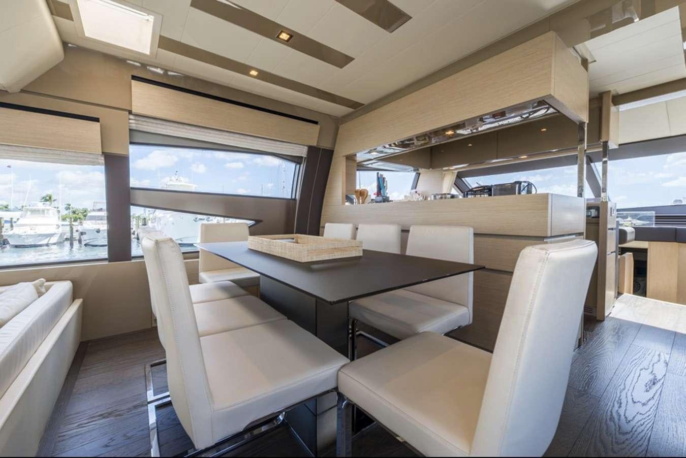 a room with a table and chairs aboard g5 Yacht for Charter