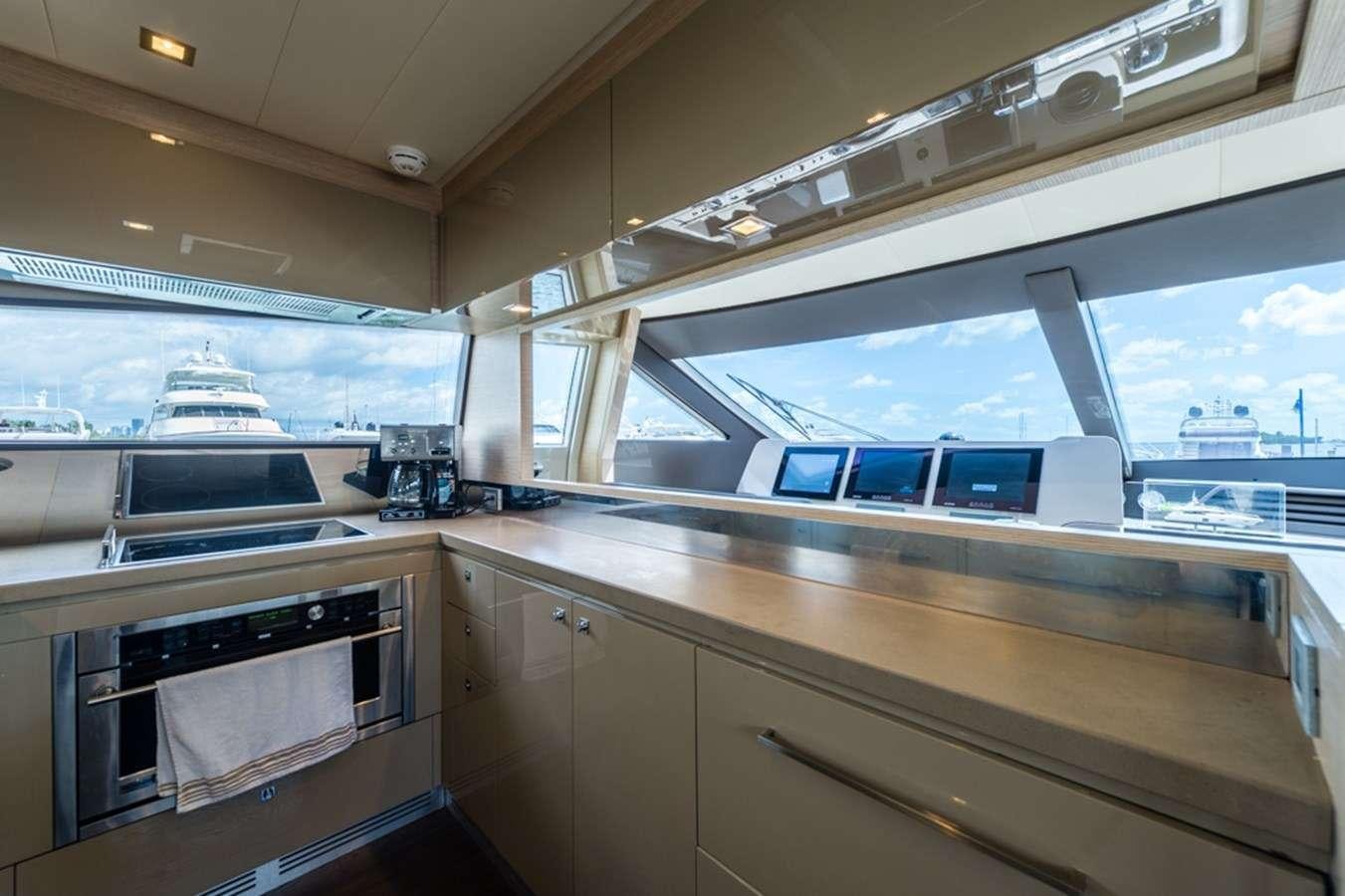 a kitchen with a large window aboard g5 Yacht for Charter