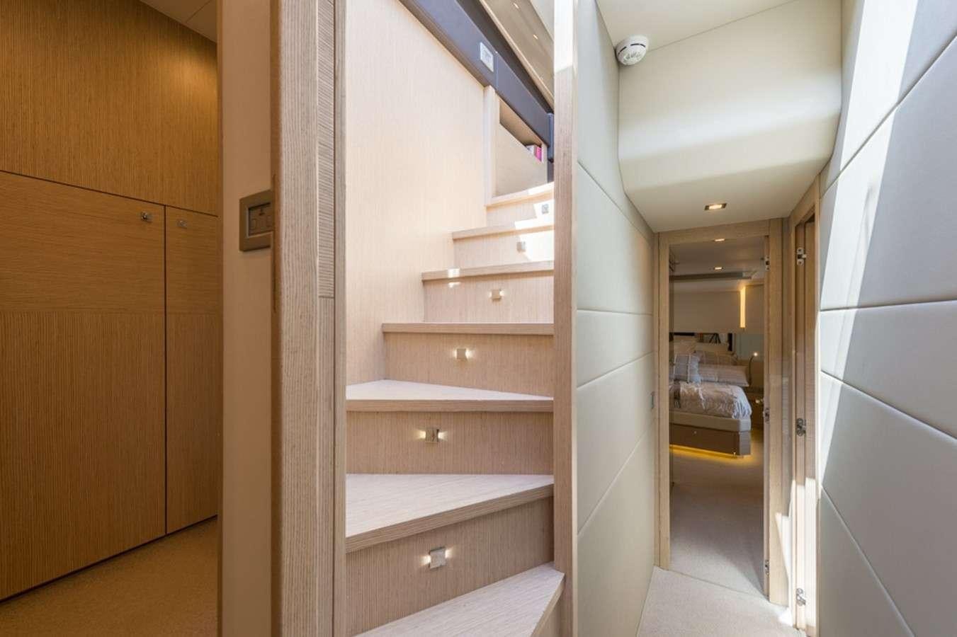 a room with a wood staircase aboard g5 Yacht for Charter