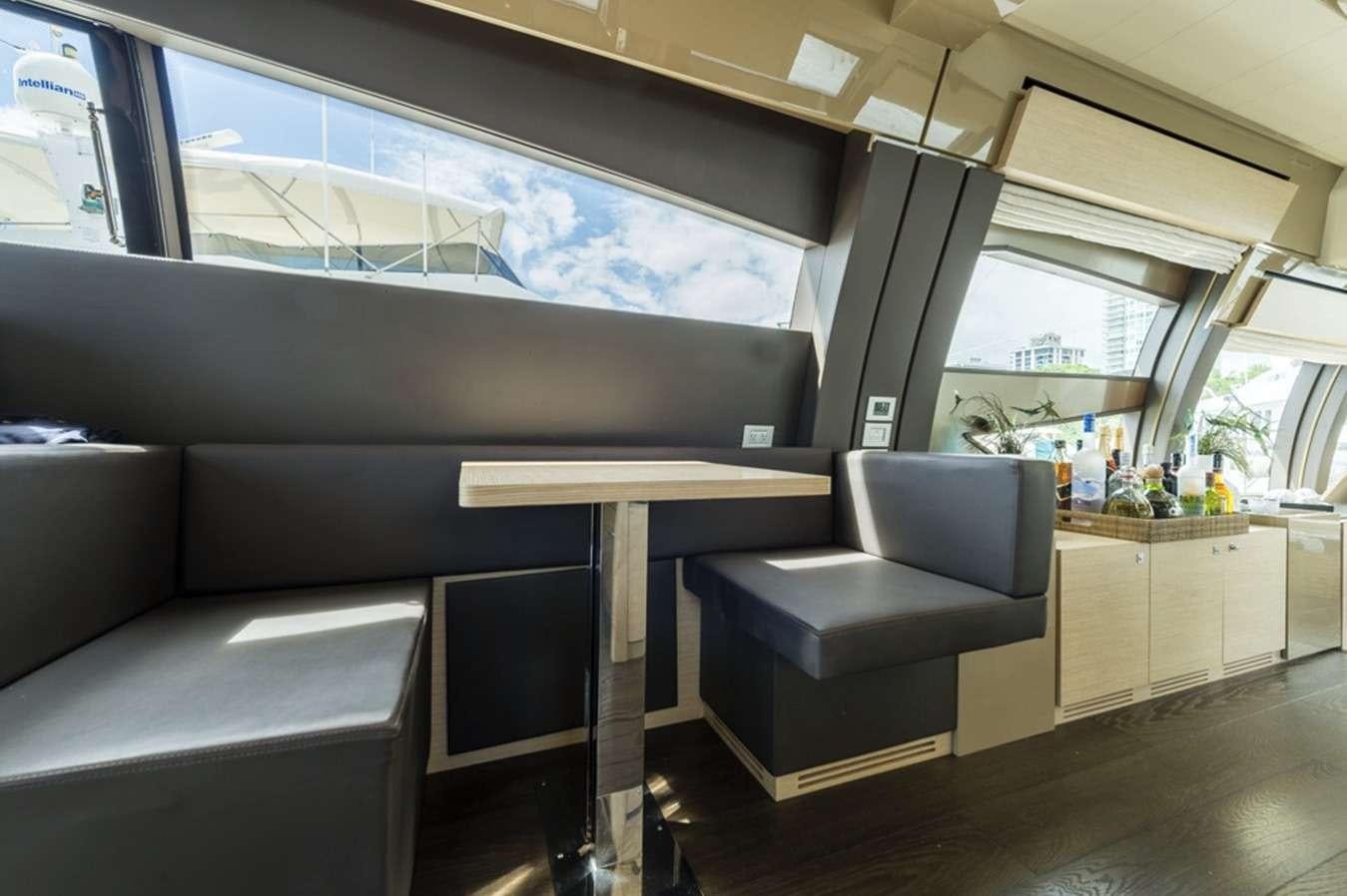 a room with a couch and a table aboard g5 Yacht for Charter