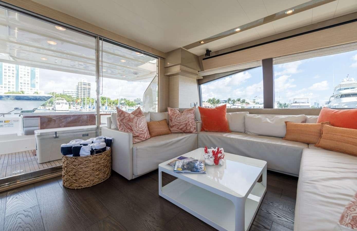 a living room with a large window aboard g5 Yacht for Charter