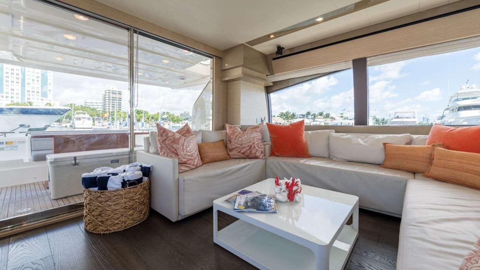 a living room with a large window aboard g5 Yacht for Charter