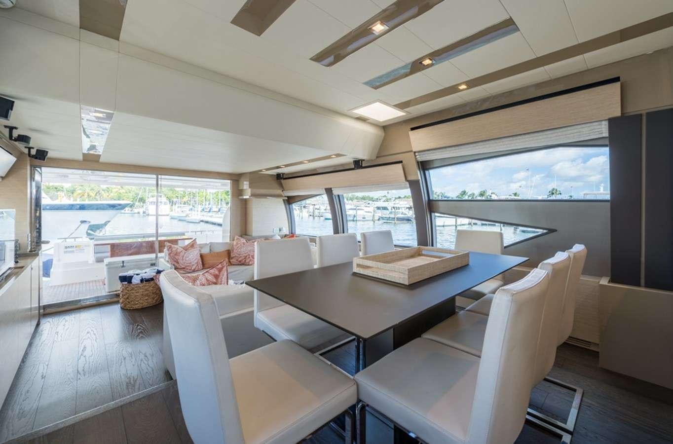 a living room with a large window aboard g5 Yacht for Charter
