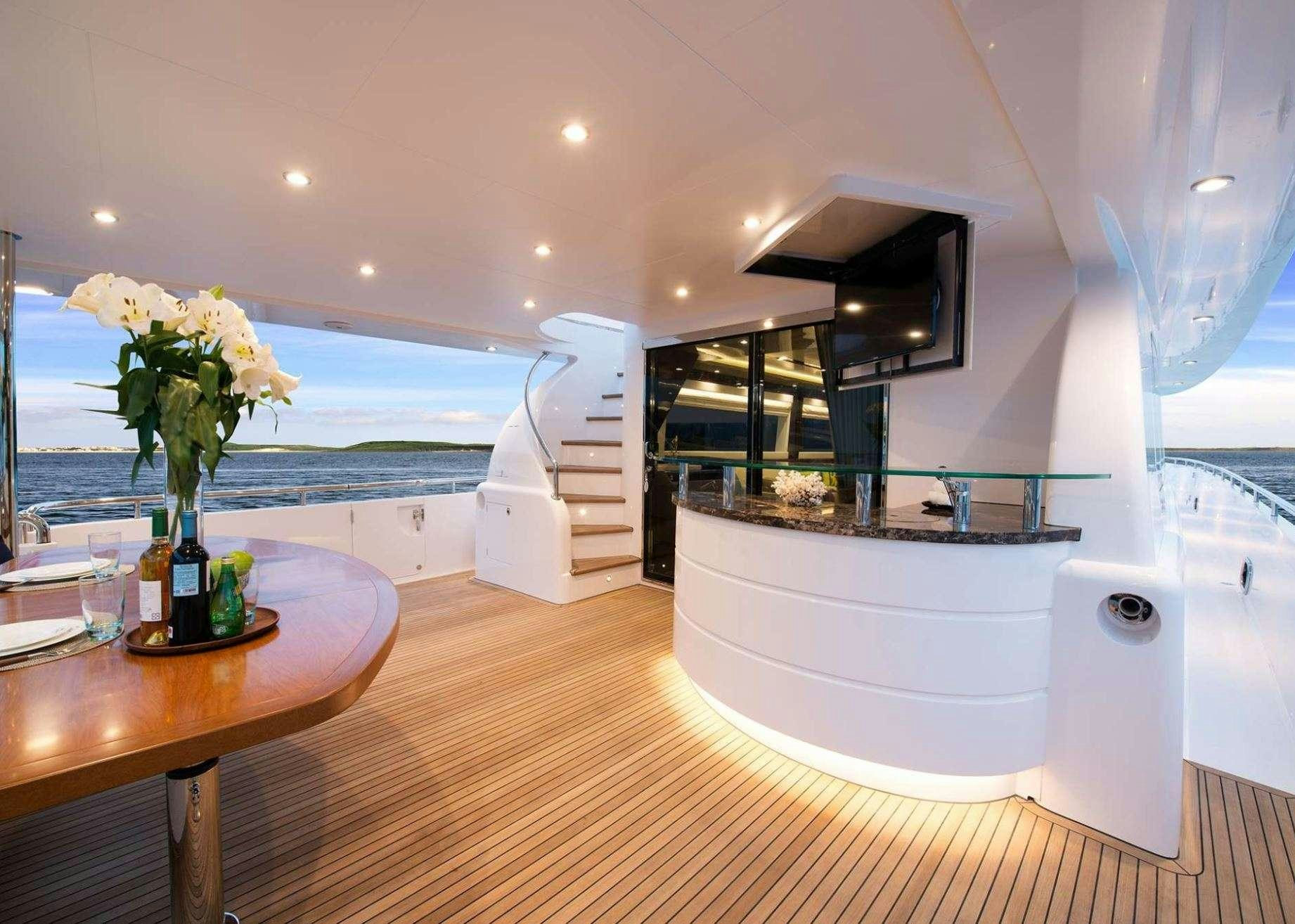 a large white bathtub in a room with a table and chairs aboard AQUA LIFE Yacht for Charter