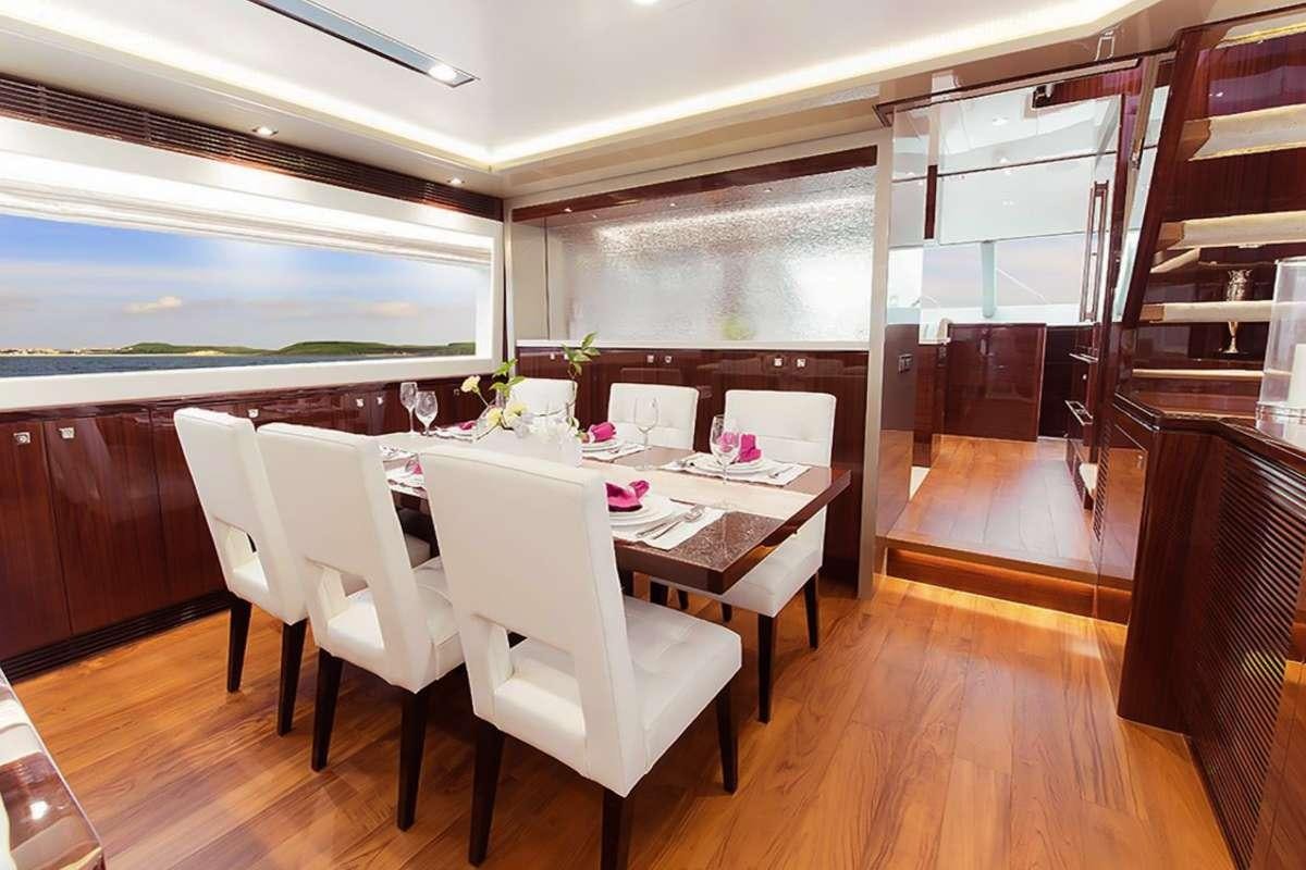 a room with a table and chairs aboard AQUA LIFE Yacht for Charter