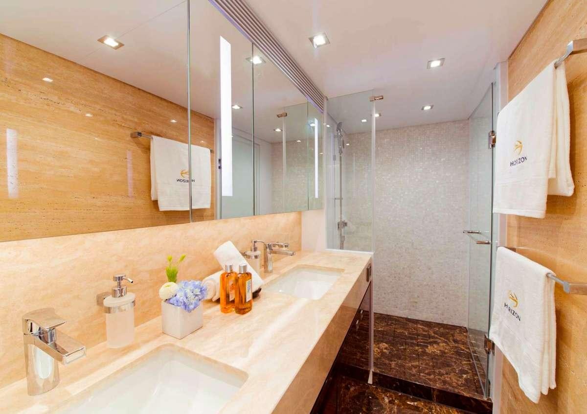 a bathroom with a countertop sink and a mirror aboard AQUA LIFE Yacht for Charter