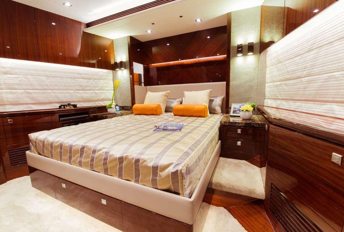 a bedroom with a bed and a desk aboard AQUA LIFE Yacht for Charter