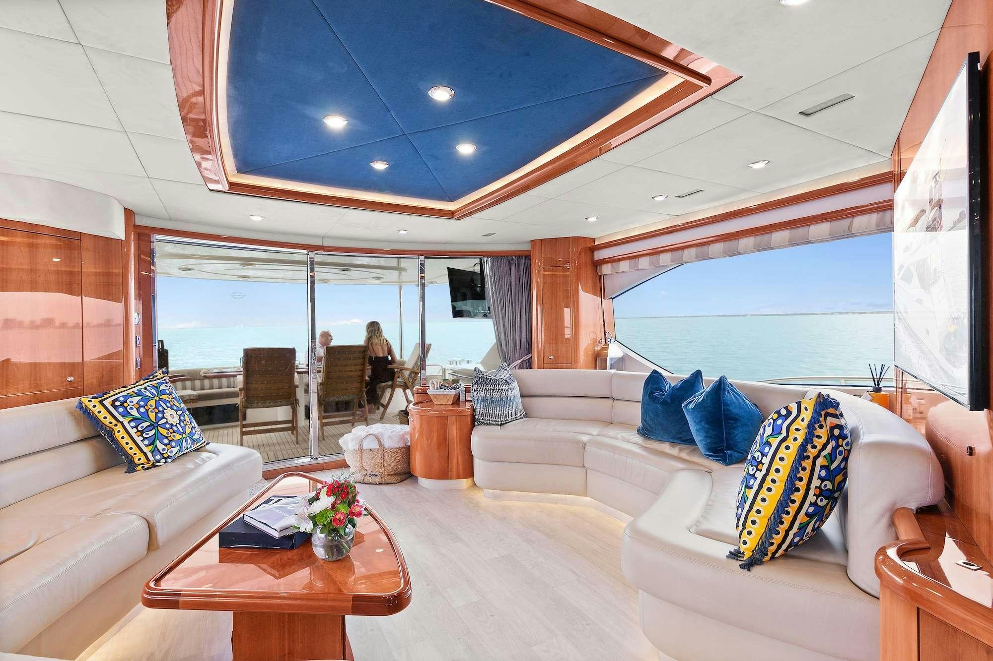 a living room with a large glass window aboard acqua alberti Yacht for Charter