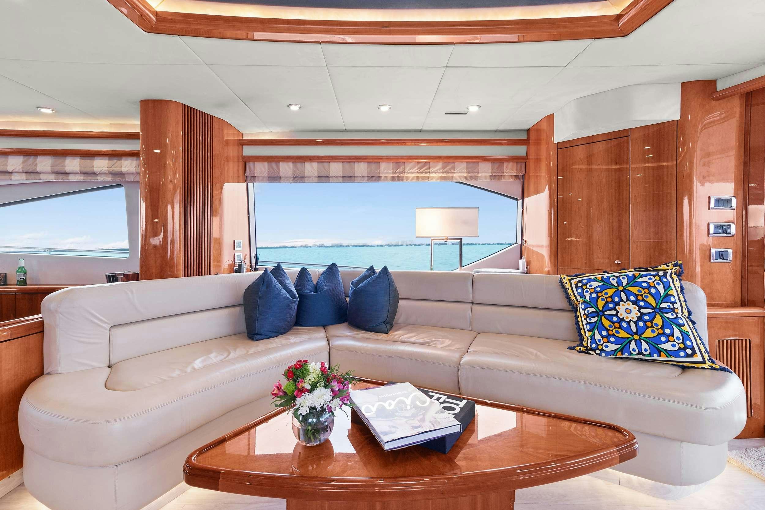 a living room with a large window aboard acqua alberti Yacht for Charter