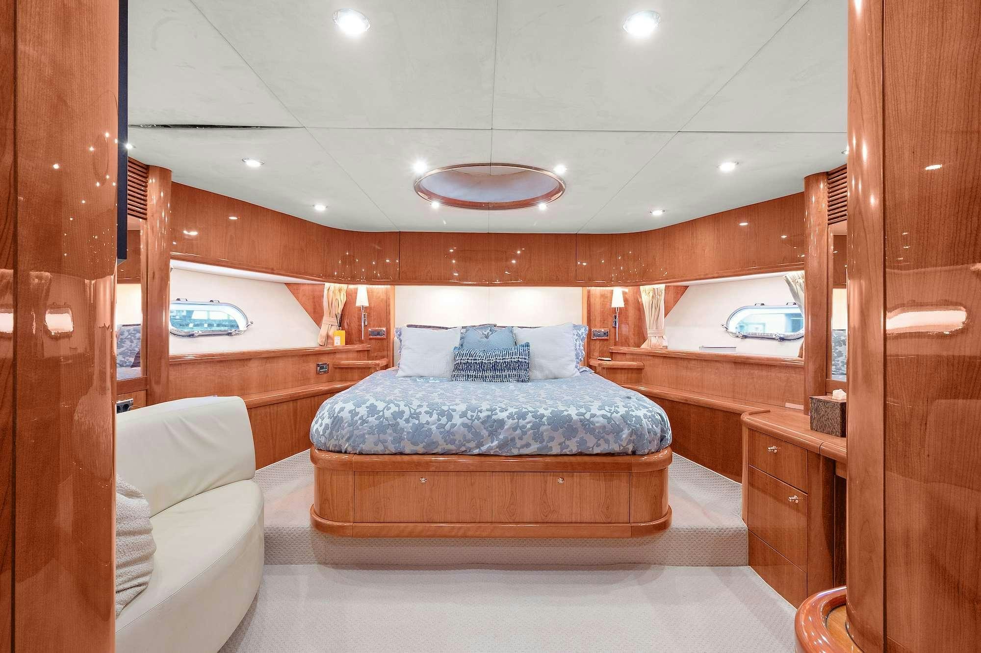 a bedroom with a bed and a mirror aboard acqua alberti Yacht for Charter
