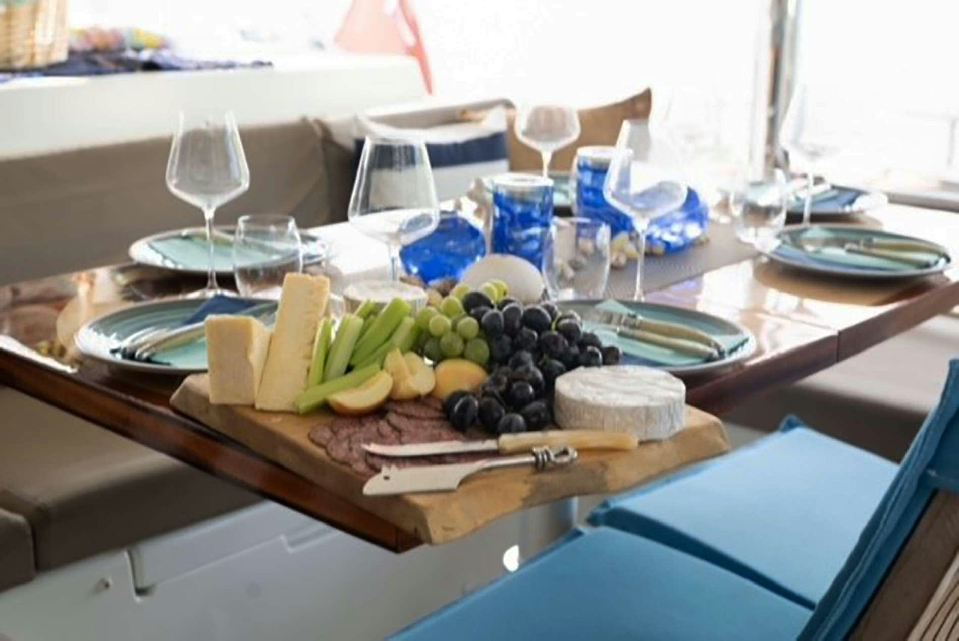 a table with food and wine aboard THE RECIPE Yacht for Charter