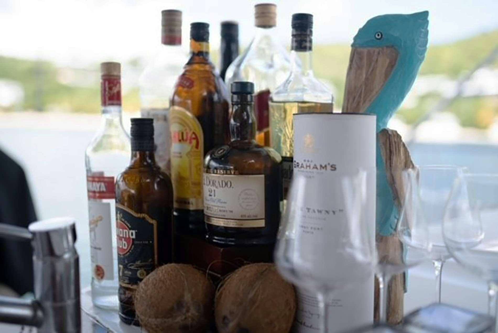 bottles of liquor and bread on a table aboard THE RECIPE Yacht for Charter