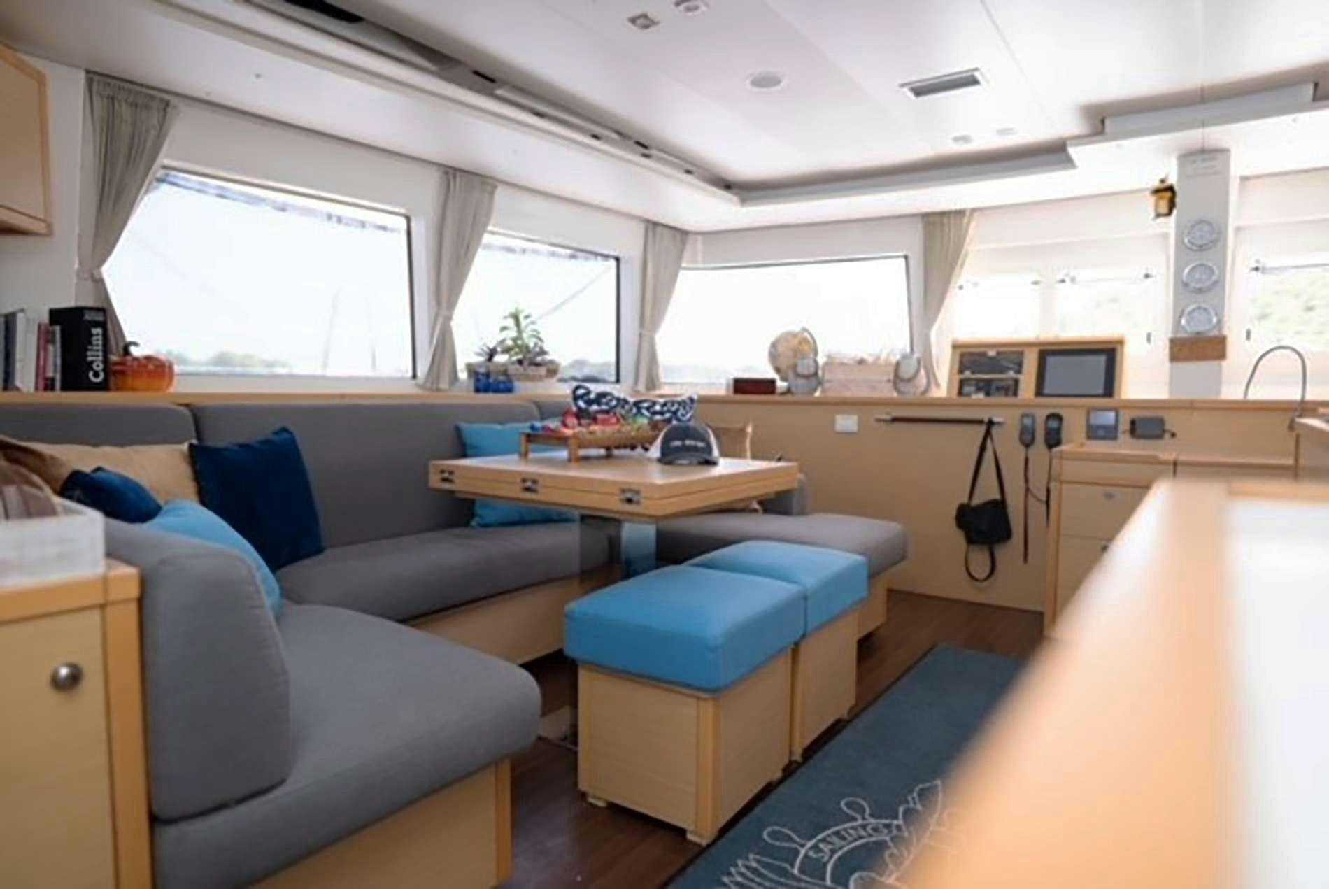 a living room with a couch and a table aboard THE RECIPE Yacht for Charter
