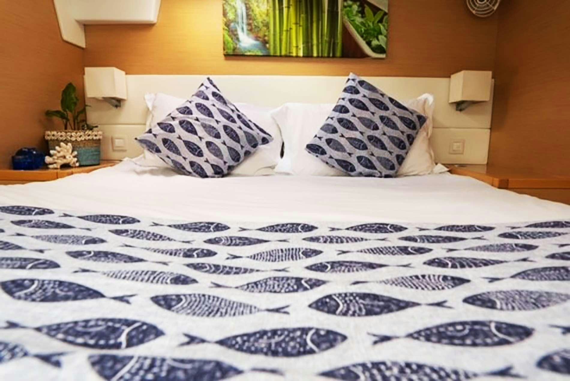 a bed with white sheets aboard THE RECIPE Yacht for Charter