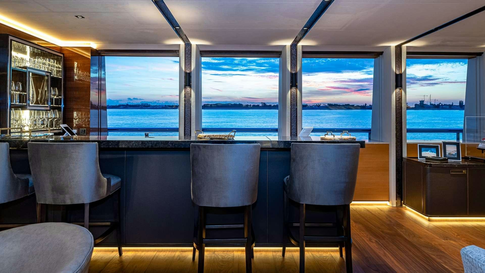 a room with a view of the ocean and a large window aboard TOP FIVE II Yacht for Charter