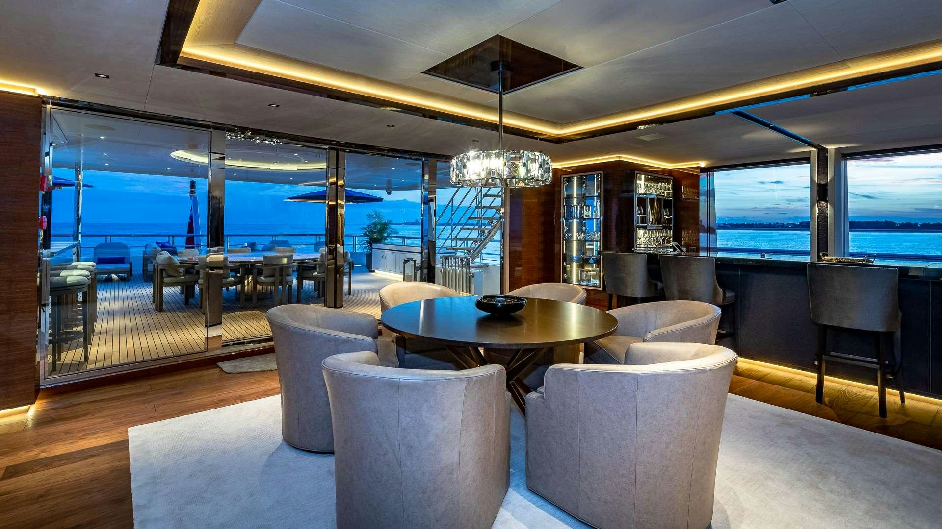a room with a table and chairs aboard TOP FIVE II Yacht for Charter