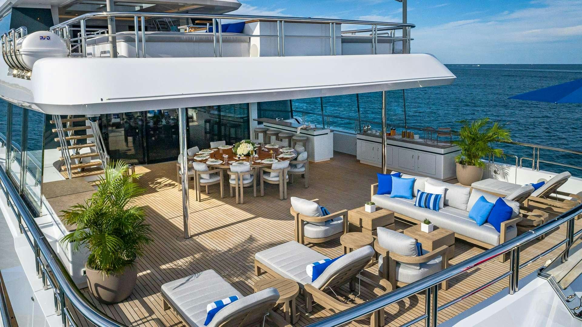 a deck with chairs and tables on it aboard TOP FIVE II Yacht for Charter
