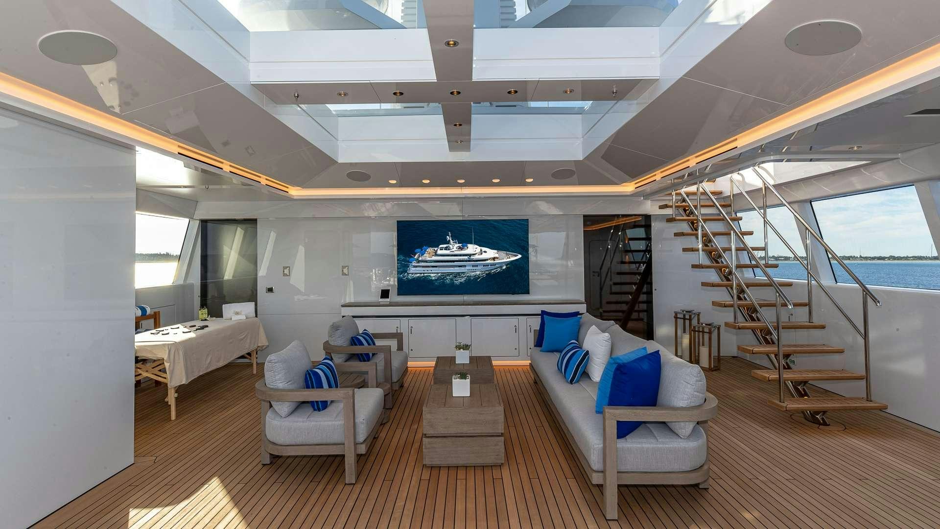 a room with a large window and a staircase aboard TOP FIVE II Yacht for Charter