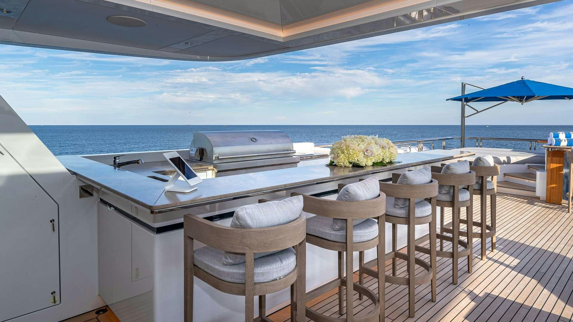 a table with chairs on it aboard TOP FIVE II Yacht for Charter