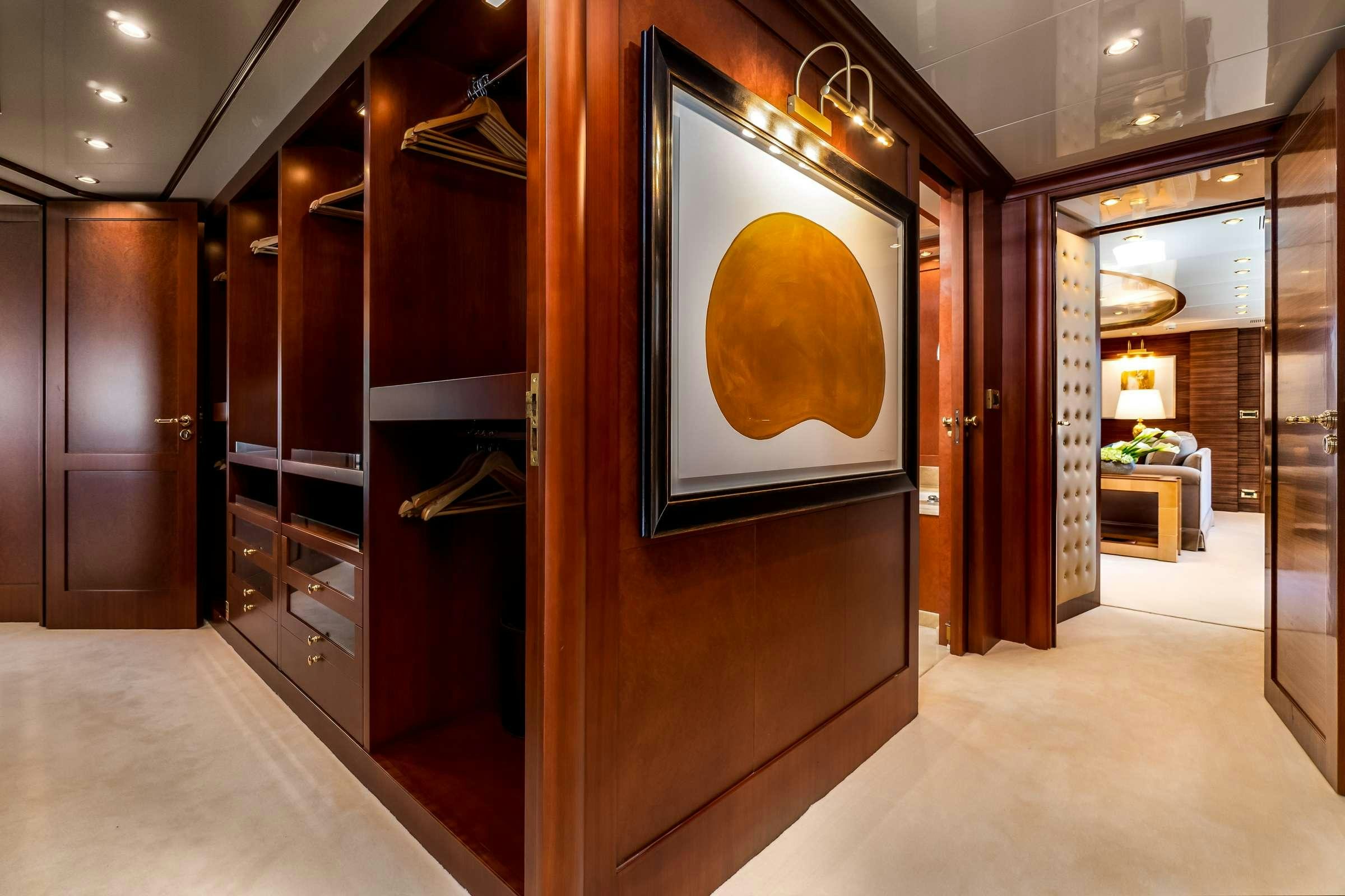 a room with a mirror and cabinets aboard OCEANOS Yacht for Charter