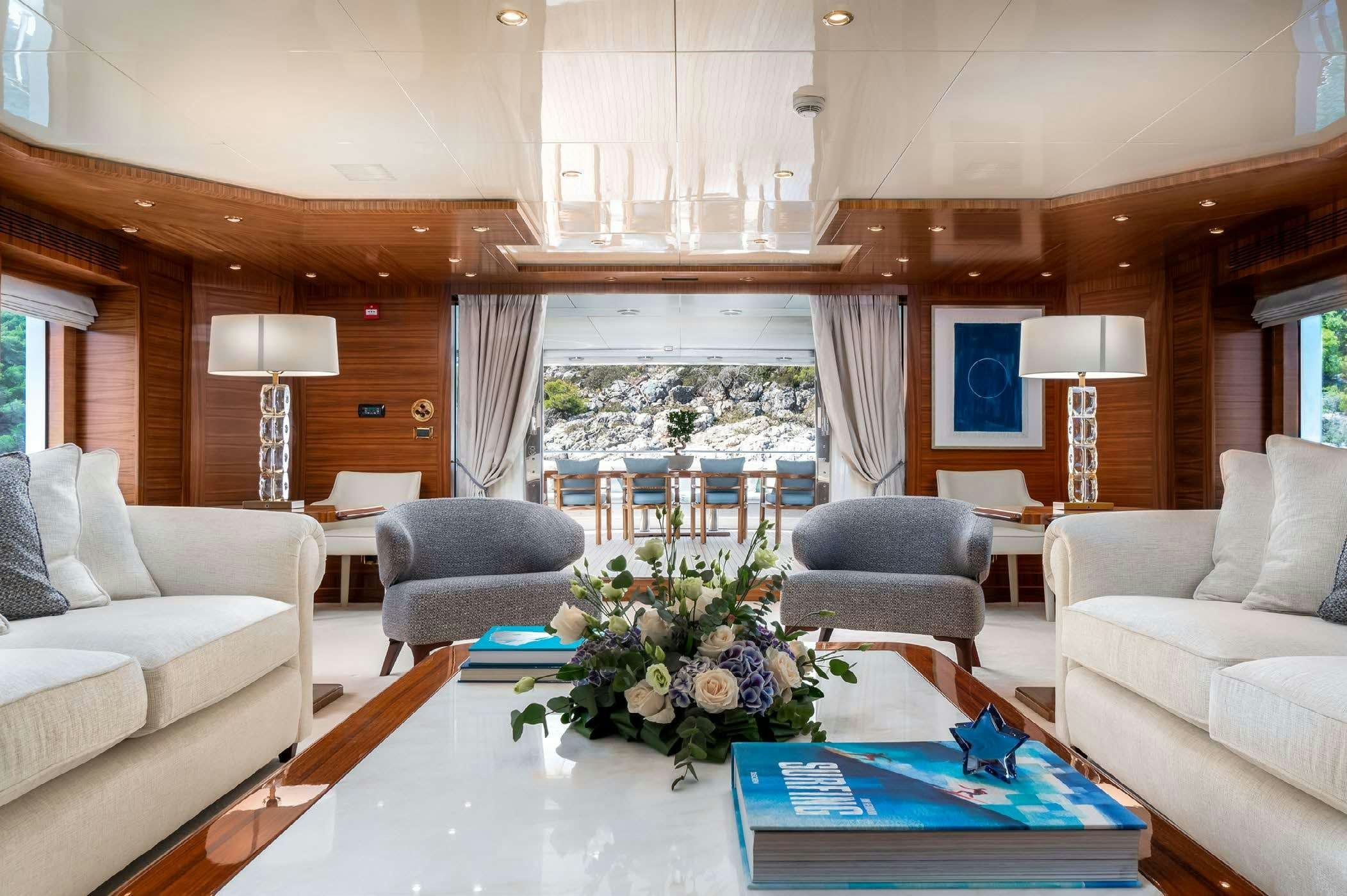 a living room with a large window aboard OCEANOS Yacht for Charter