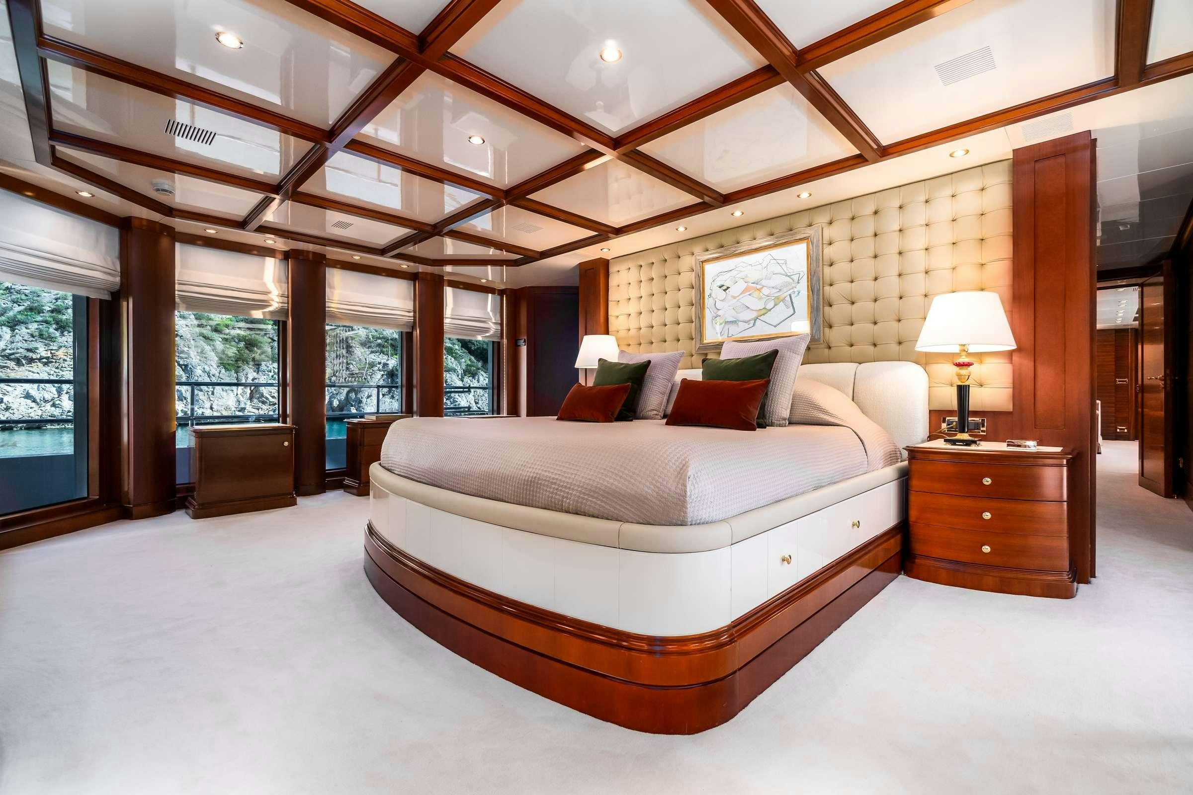 a large bed in a room aboard OCEANOS Yacht for Charter