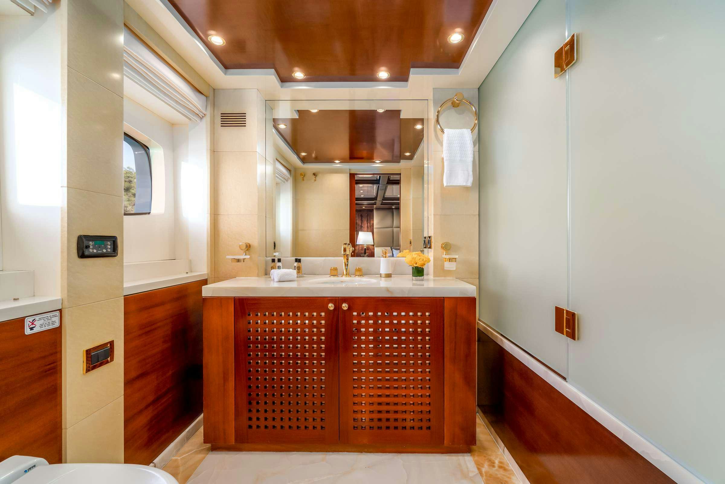 a bathroom with a sink and cabinets aboard OCEANOS Yacht for Charter