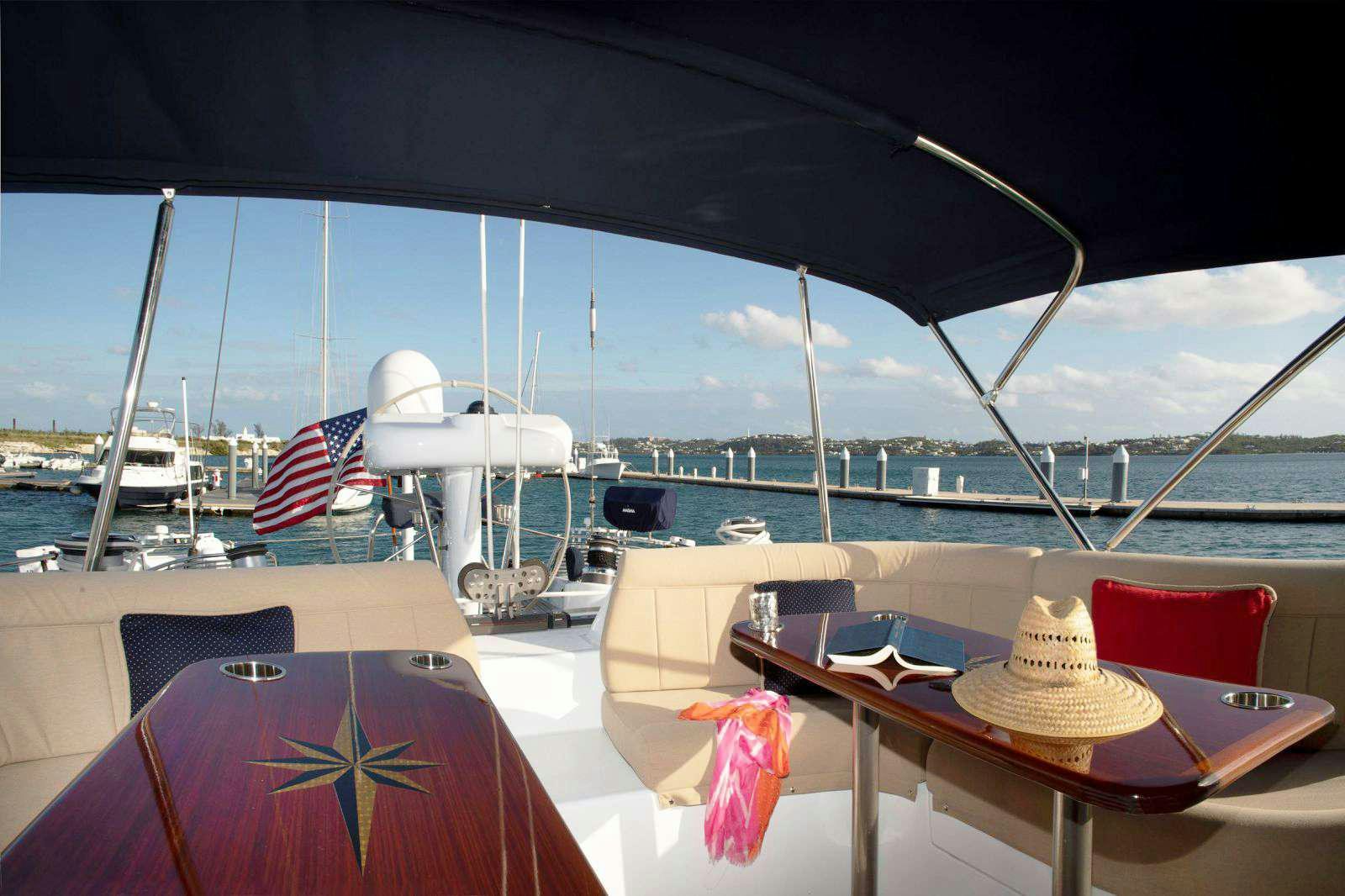 a boat with a flag on the deck aboard FALCON Yacht for Charter