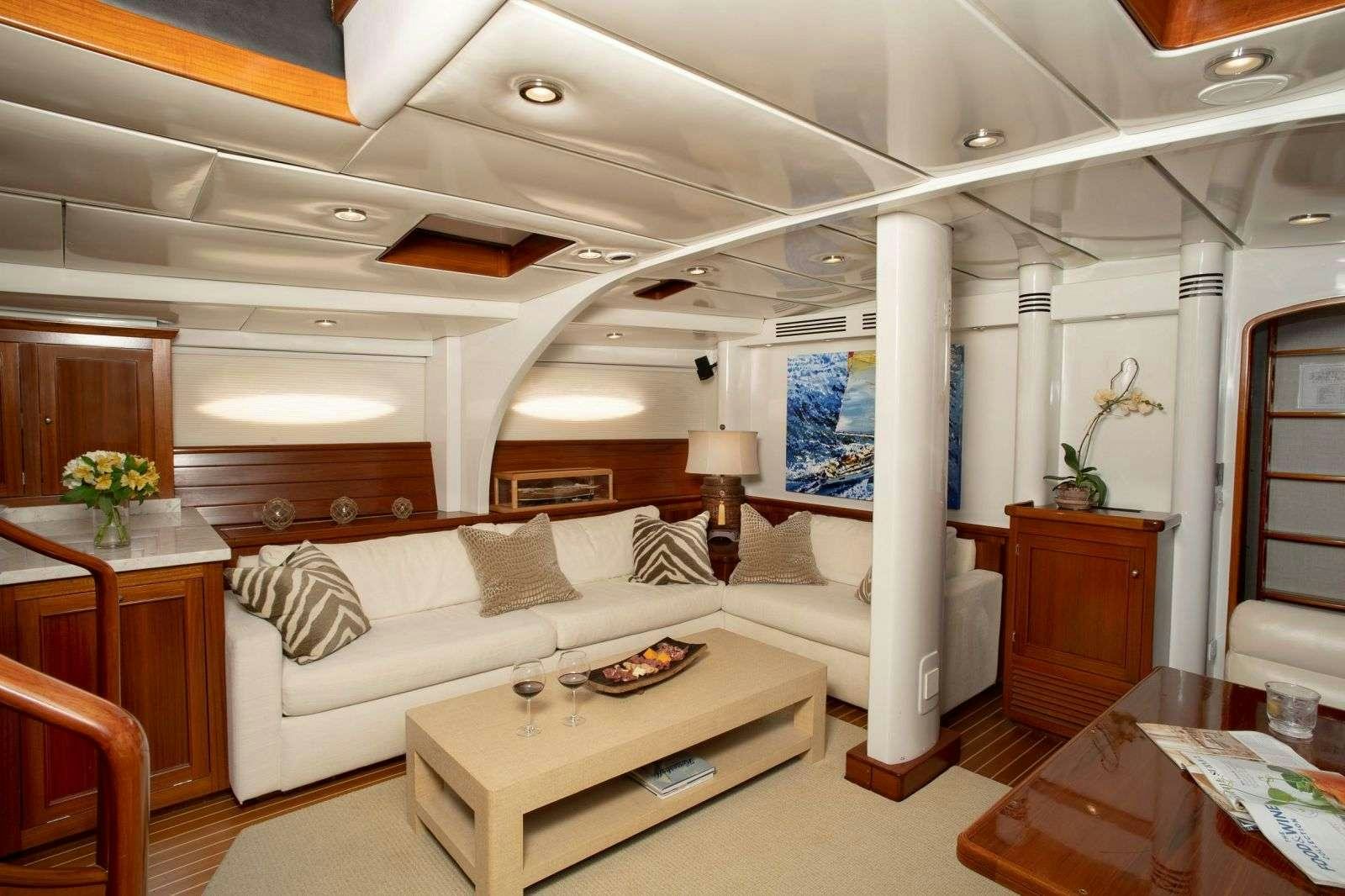 a living room with a large white column and a white couch aboard FALCON Yacht for Charter