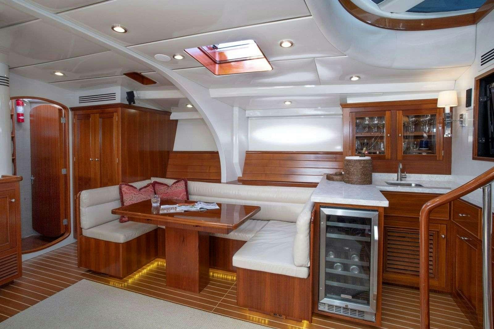 a room with a table and couch aboard FALCON Yacht for Charter