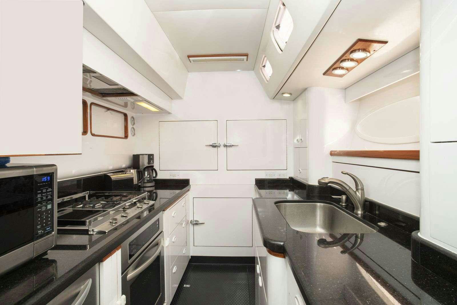 a kitchen with white cabinets aboard FALCON Yacht for Charter
