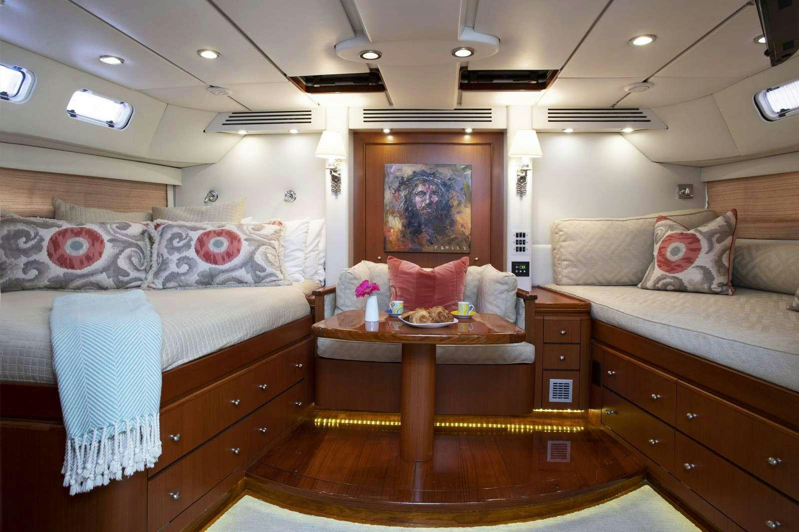 a bedroom with a bed and a desk aboard FALCON Yacht for Charter