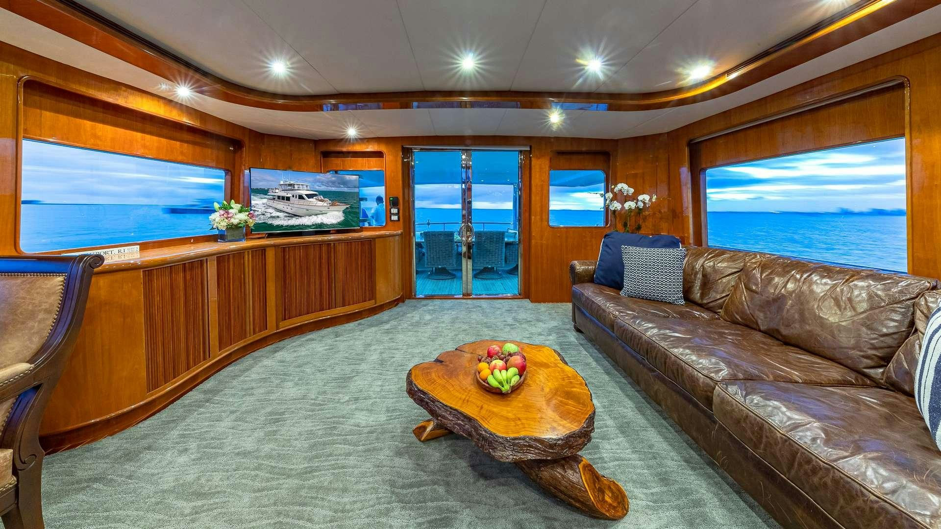a living room with a couch and a table aboard SAFARI Yacht for Charter
