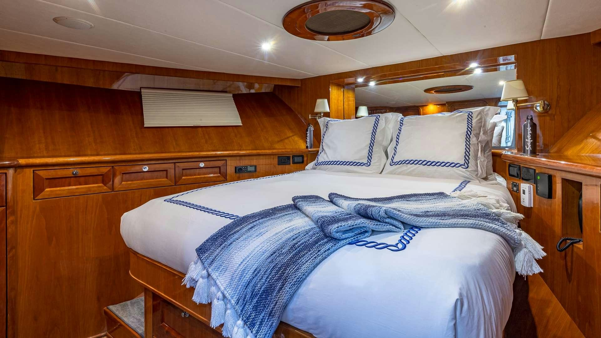 a bedroom with a bed and a desk aboard SAFARI Yacht for Charter