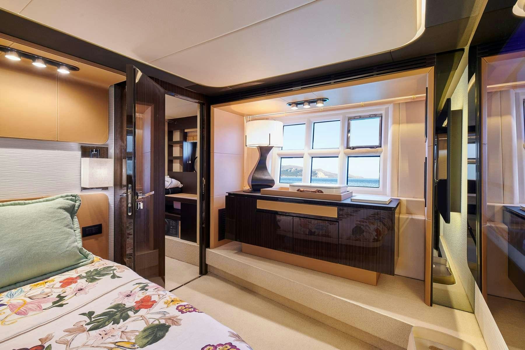 a bedroom with a bed and a desk aboard ALKYONE Yacht for Charter