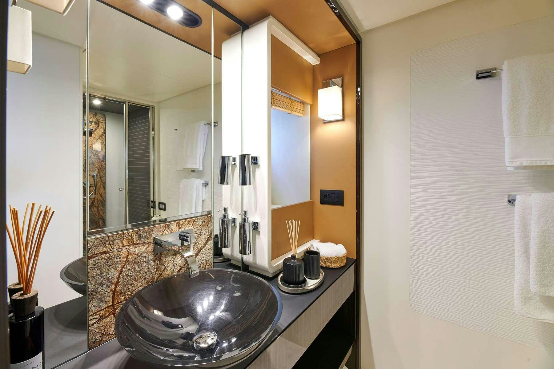a bathroom with a large mirror aboard ALKYONE Yacht for Charter