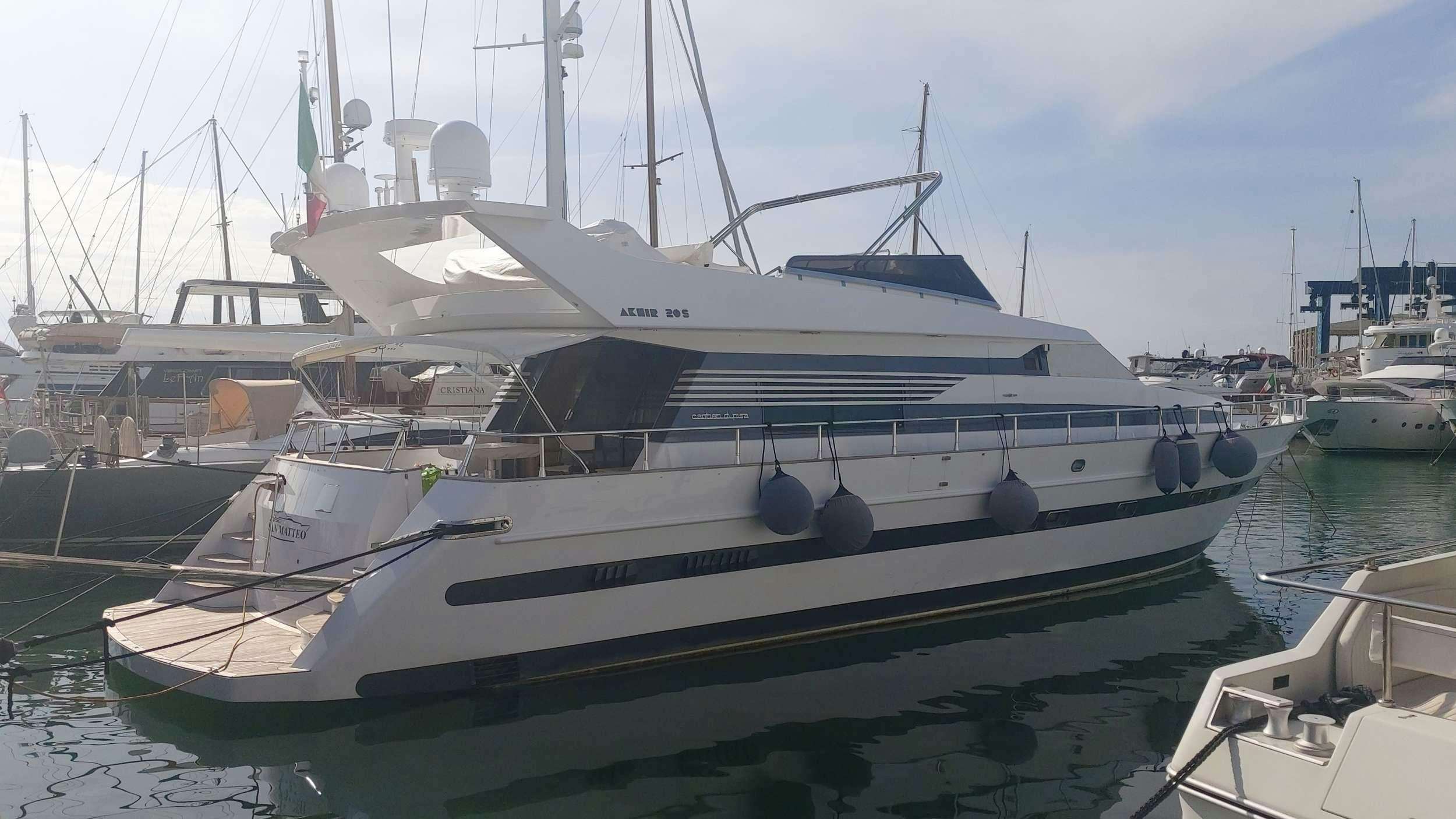 a boat docked in a harbor aboard San Matteo Yacht for Charter