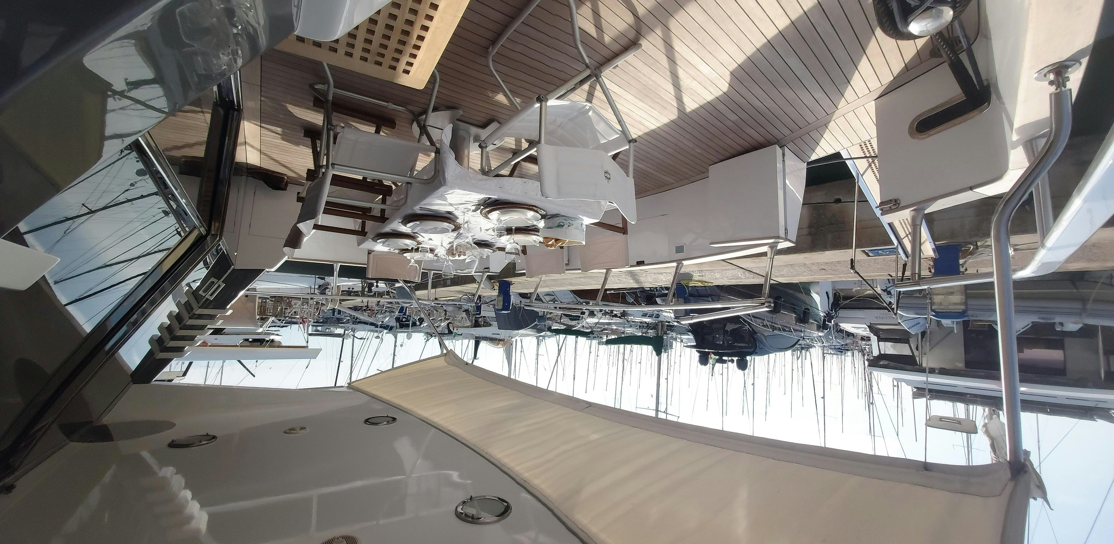 a large room with a large white ceiling and a few chairs aboard San Matteo Yacht for Charter