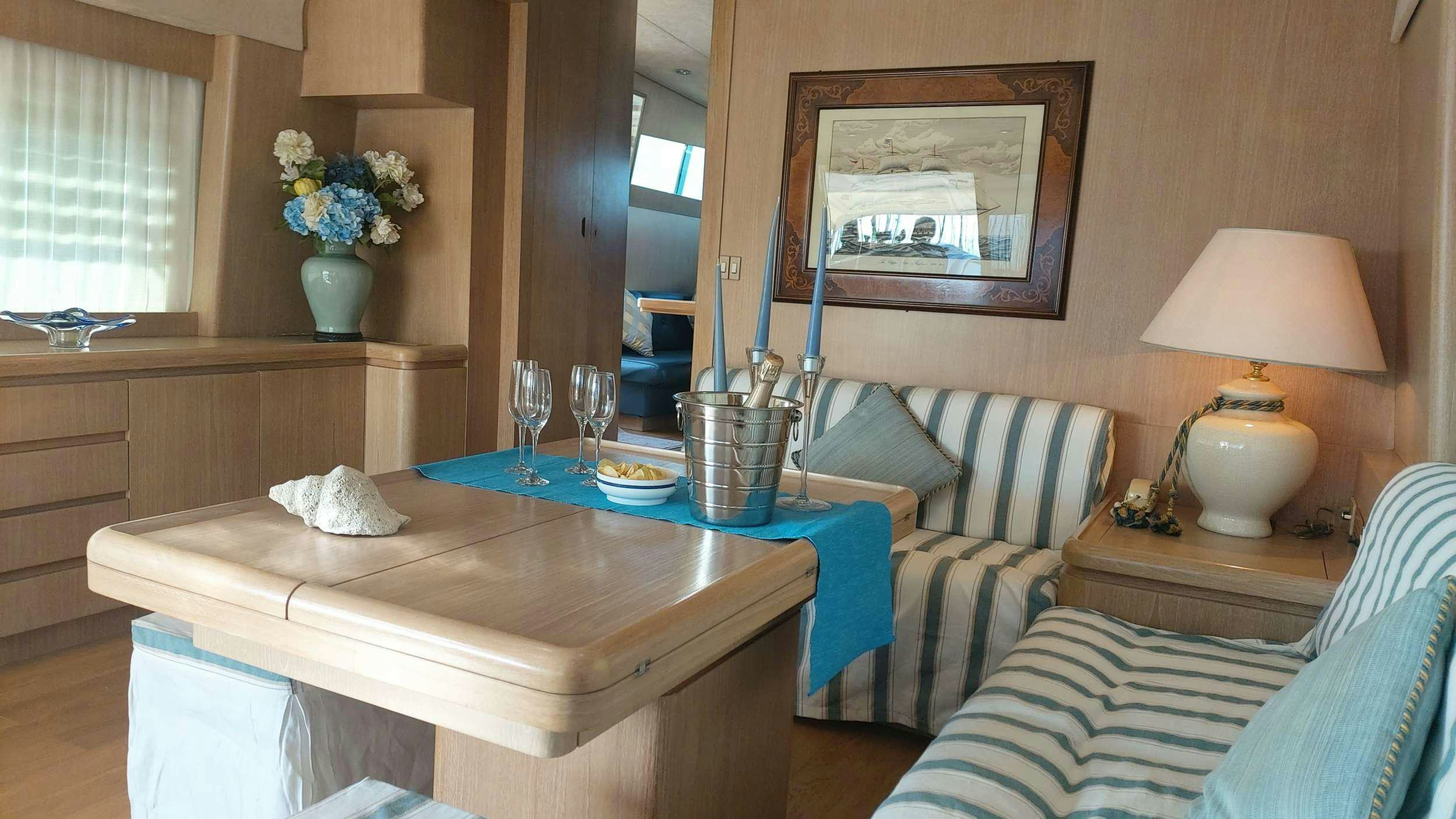 a living room with a table and couches aboard San Matteo Yacht for Charter
