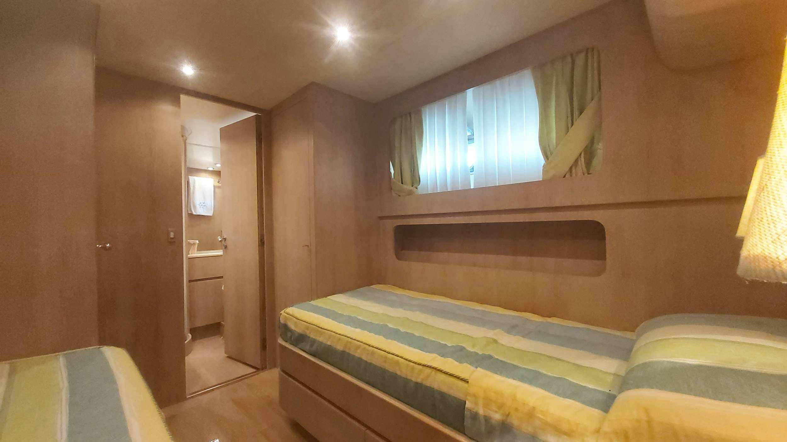 a room with a bed and a window aboard San Matteo Yacht for Charter