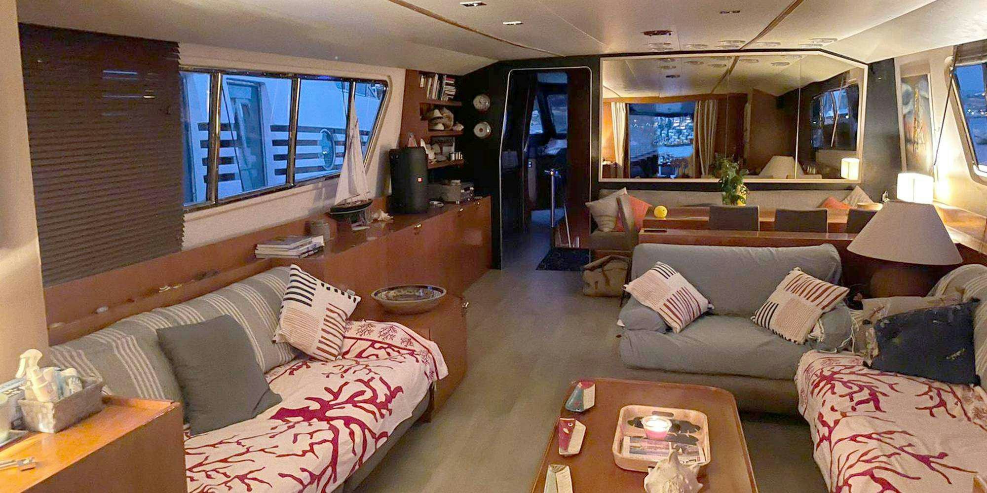 a living room with a couch and a coffee table aboard SEA SEVEN Yacht for Charter