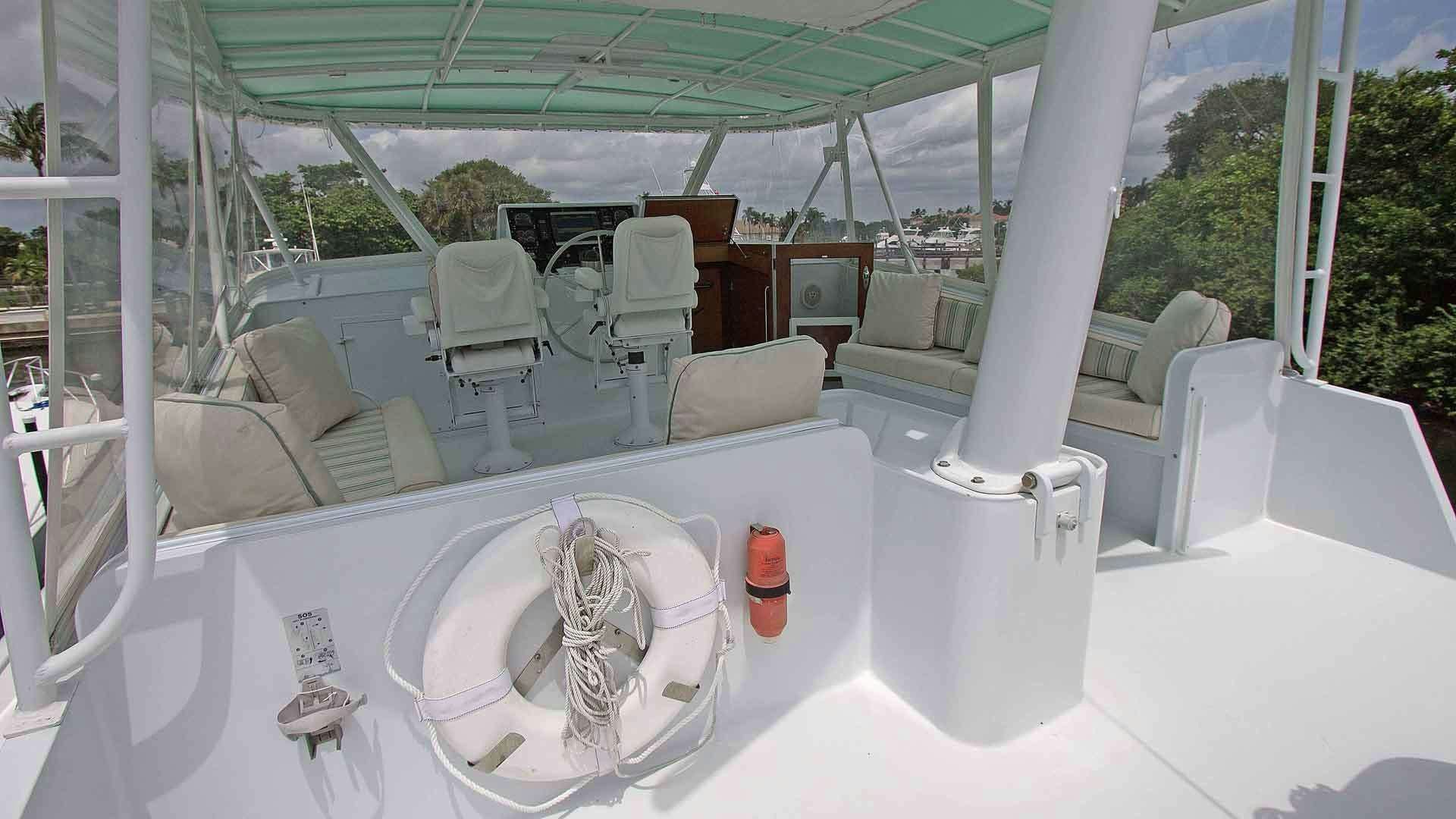 a white bathtub with a sink and chairs in a room with a window and a view of aboard KOALA Yacht for Charter